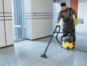 full-shot-man-vacuuming-office-floor